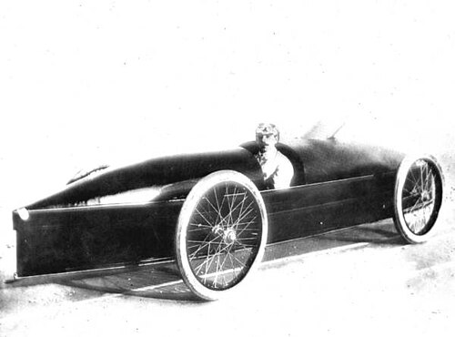 Period photograph of Fred Marriott seated in the Stanley Rocket at Daytona Beach, dated 1906 or 1907 by the source. The complete streamliner is clearly visible.