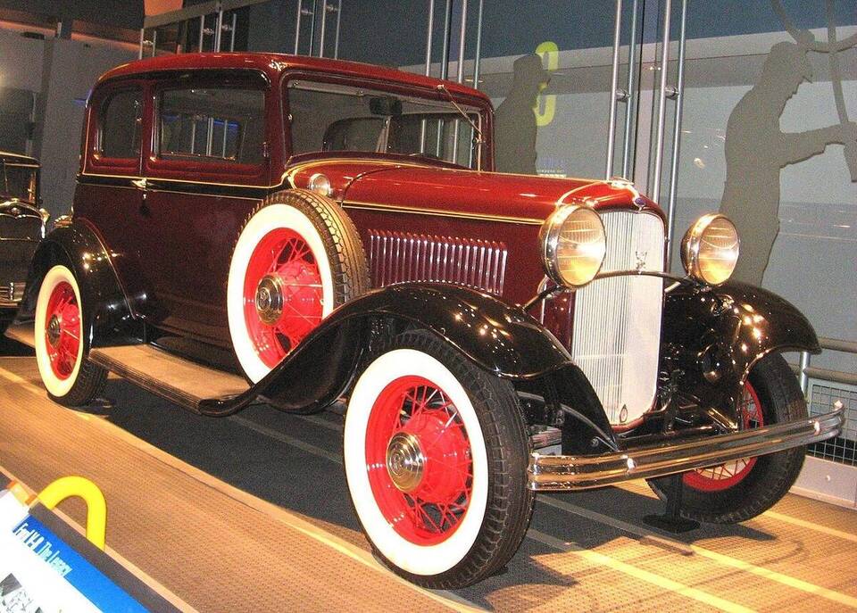 Commons identifies a 1932 Ford V-8 Model 18 Standard Tudor Sedan photographed in Dearborn, Michigan. This matches the profile's exact year, engine family, Standard trim, body and U.S. context.