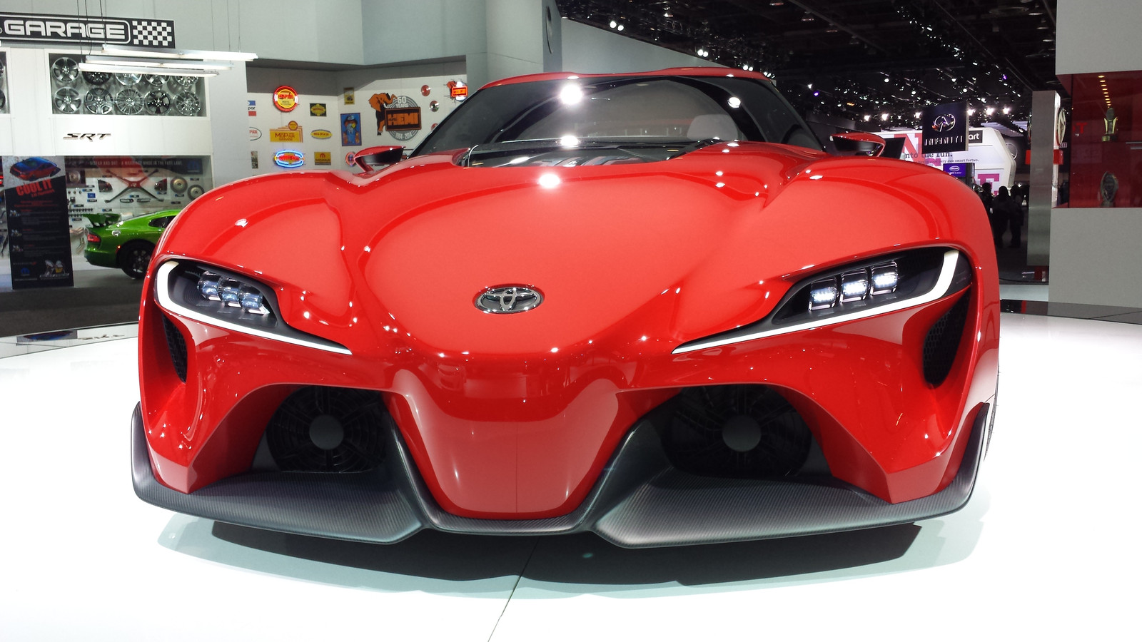 Physical red Toyota FT-1 concept photographed at the 2014 North American International Auto Show. The image establishes the original red Calty show car, not the later graphite interpretation, FT-1 Vision Gran Turismo derivative, a production Supra, or any production powertrain specification.