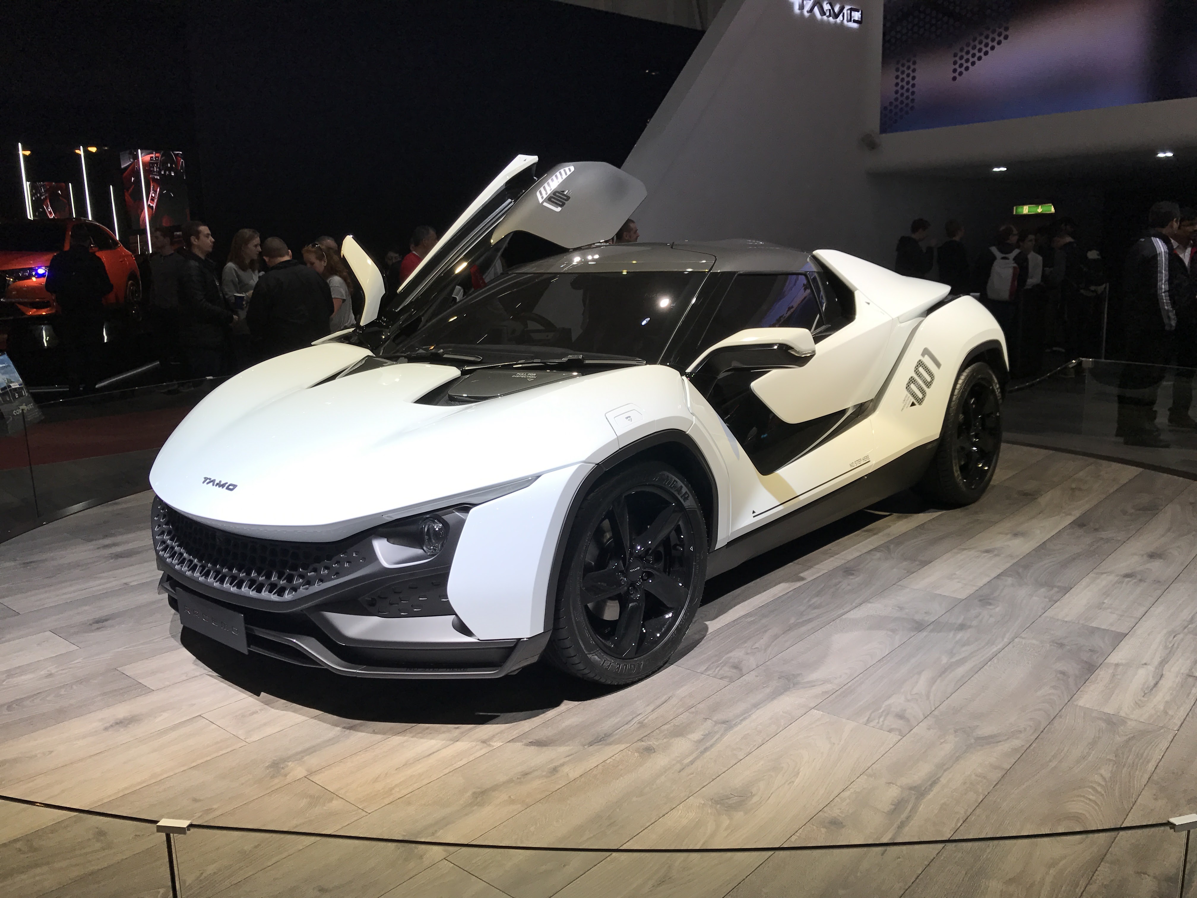 Exact physical Geneva RACEMO exhibit. White-and-black show car with a raised door; not a production-car or game-performance claim.