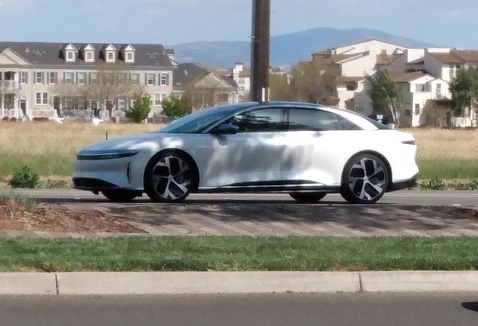 Exact 2022 Lucid Air Dream Edition; Range versus Performance subvariant and 19-inch Aero Range wheel specification are not independently stated or verifiable from this side view.
