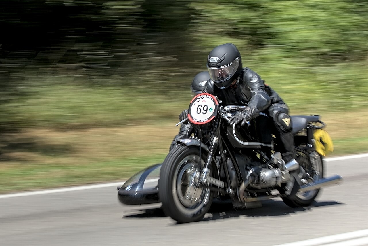 Source identifies a 1960 BMW R69S at Solitude Revival 2022. Representative sidecar-equipped event vehicle with rider, number plate and visible Earles fork; not a factory-standard solo configuration.