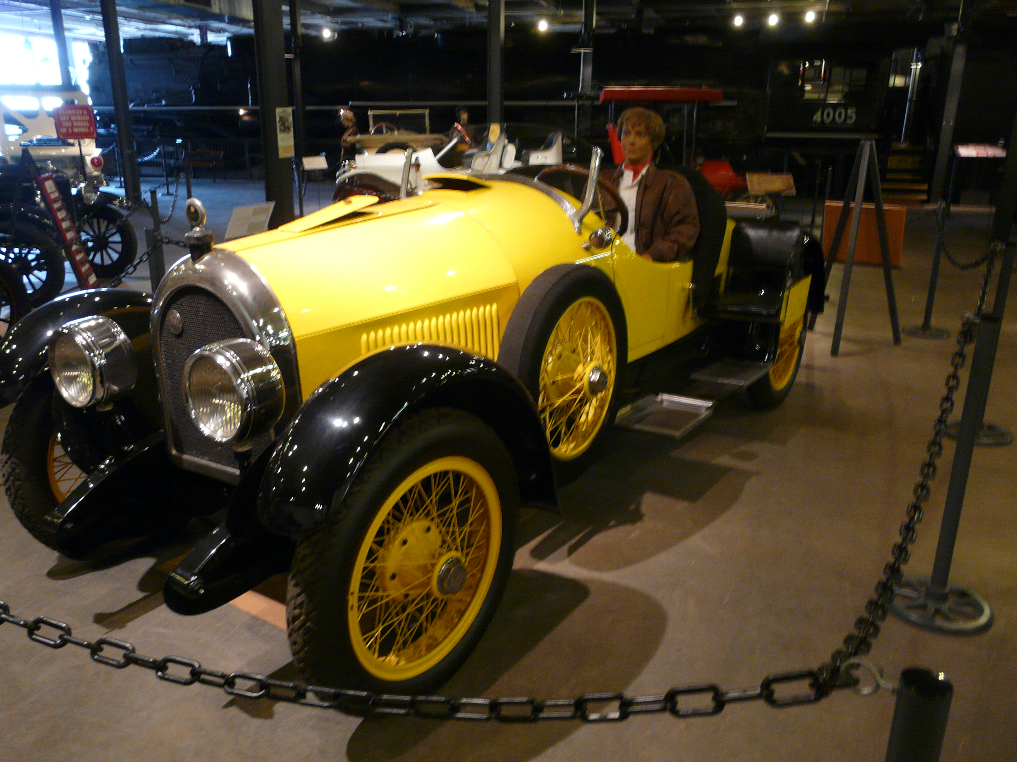 Yellow-and-black 1923 Kissel Model 45 Goldbug formerly owned by Amelia Earhart, displayed with an Earhart figure in the Forney Museum in 2012.