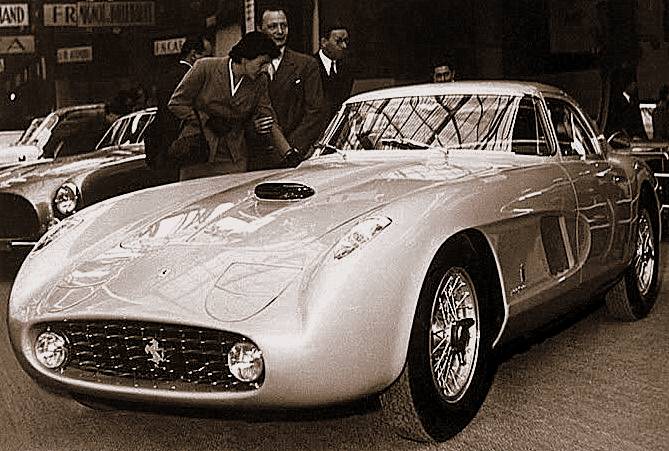 Ingrid Bergman and Roberto Rossellini stand behind the actual pale Ferrari 375 MM Pinin Farina Coupé Speciale at the 1954 Paris motor show.
