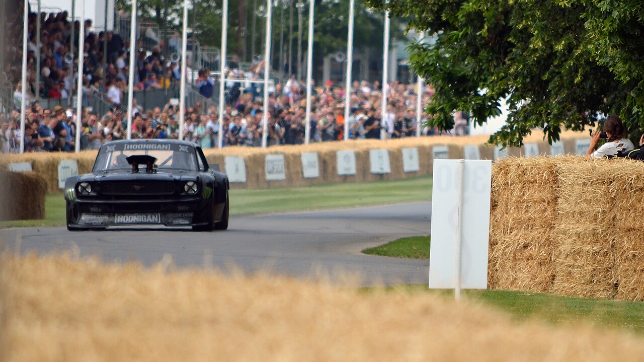 Ken Block's black Hoonicorn RTR V1 driving toward the camera on the Goodwood hillclimb in 2015.