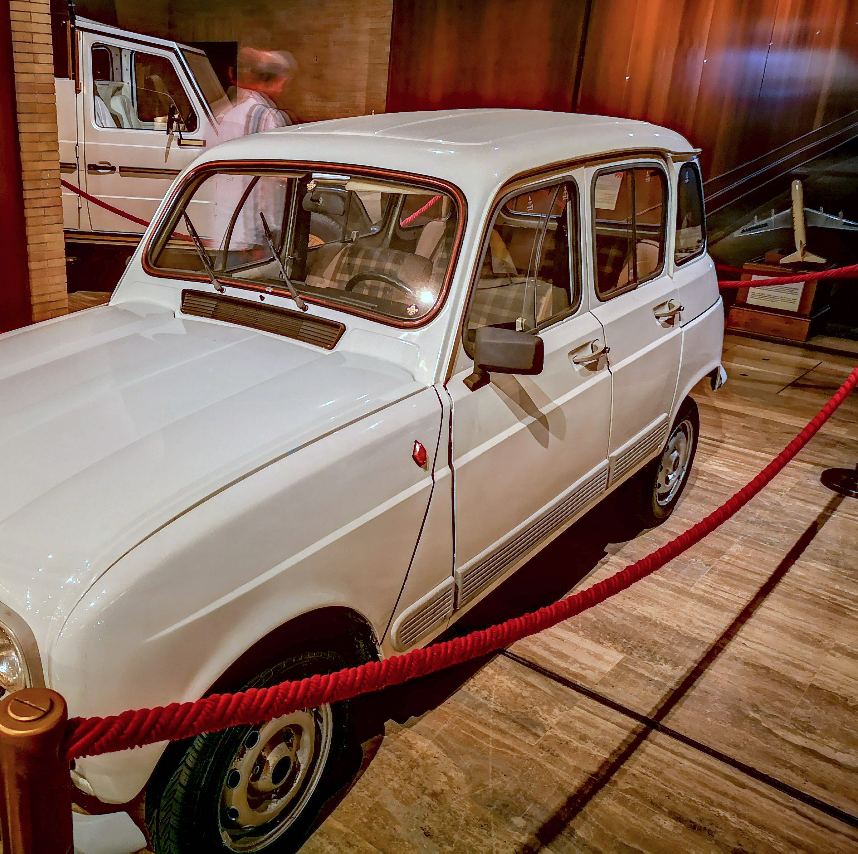 Pope Francis’s white 1984 Renault 4 displayed behind red ropes in the Vatican Museums; the registration is outside Joyride’s crop.