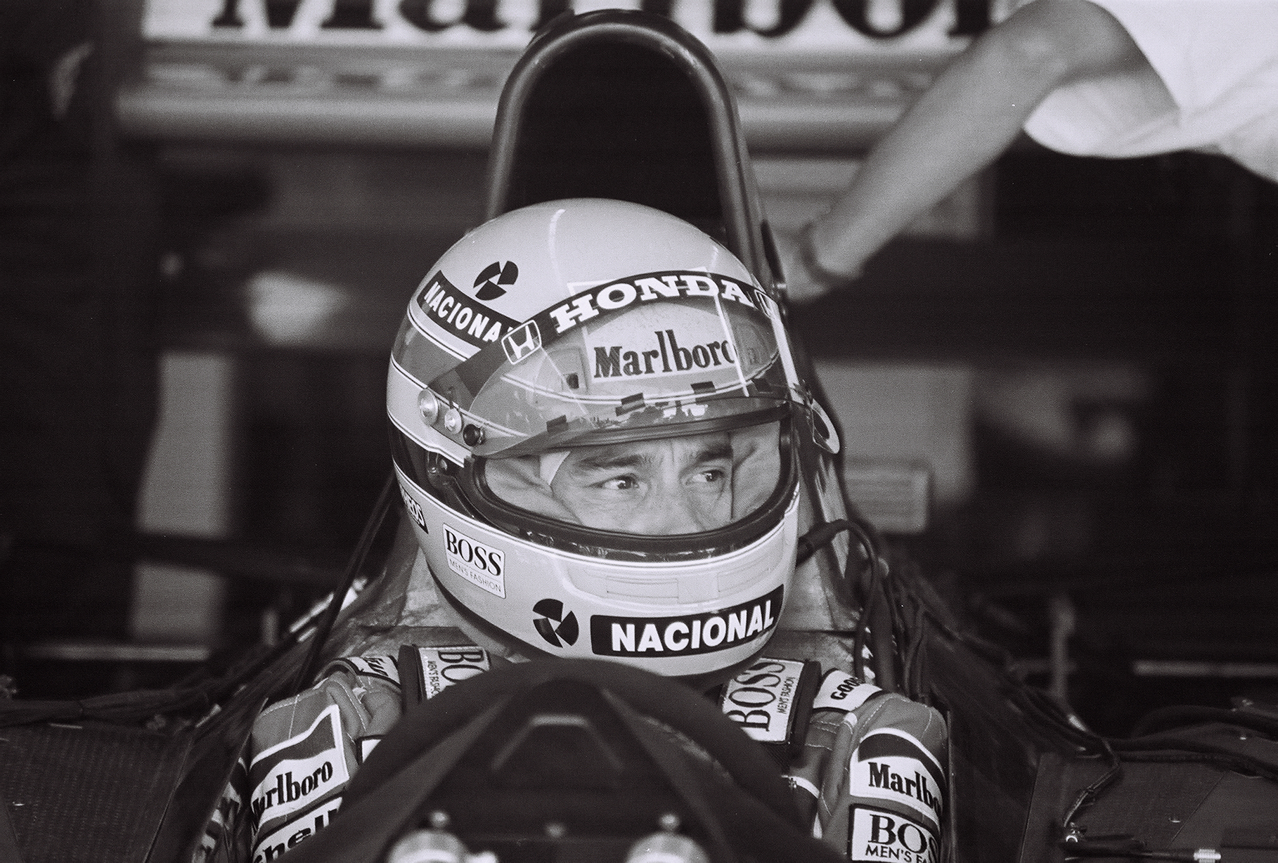 Ayrton Senna wearing his helmet in the cockpit at the 1991 United States Grand Prix, photographed by Stuart Seeger.
