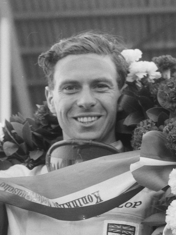 Jim Clark holding a wreath and trophy after winning the 1963 Dutch Grand Prix, photographed by Joop van Bilsen for Anefo.
