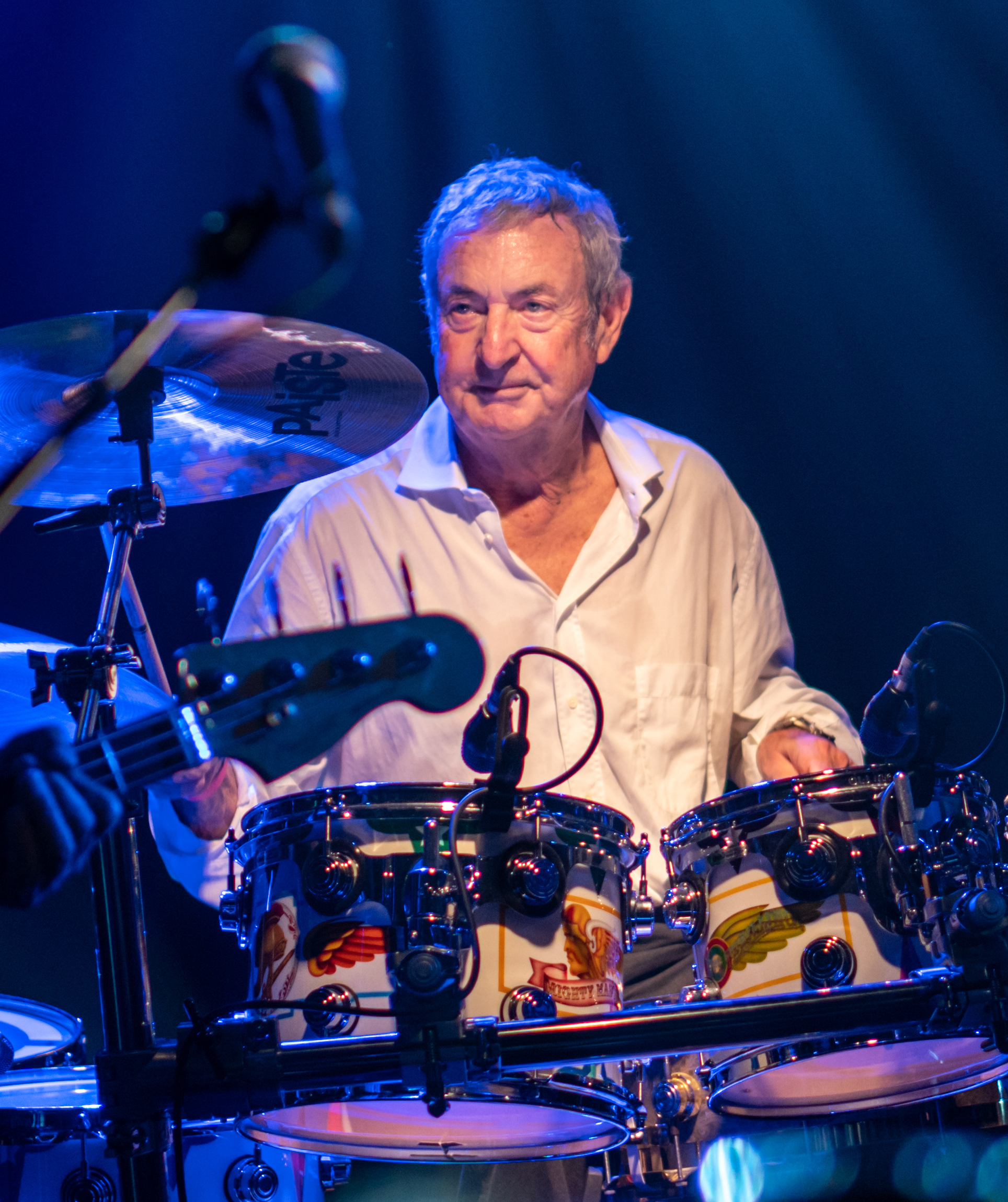 Nick Mason performing at a drum kit in a May 2018 identification portrait by Raph_PH.