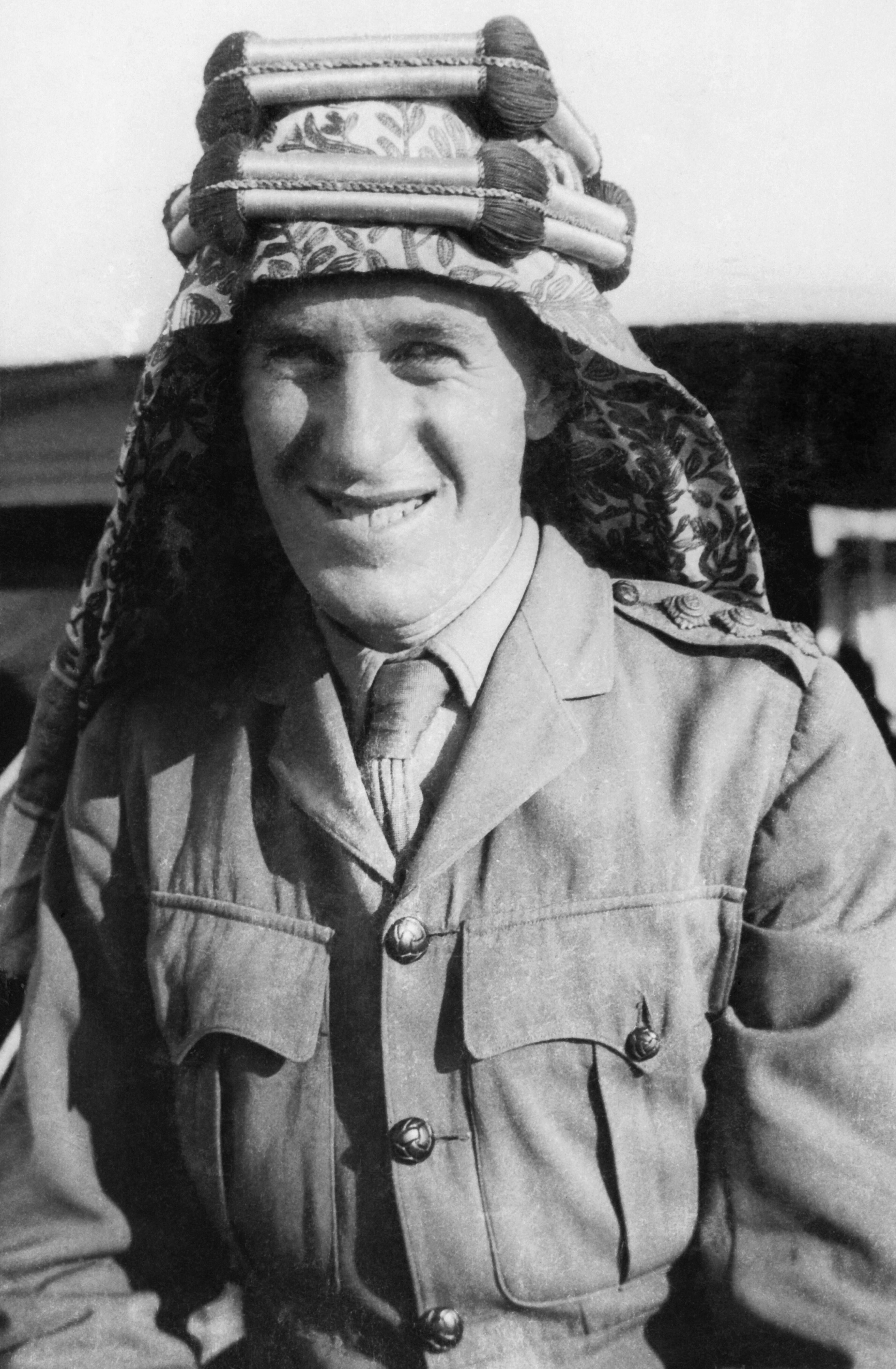 T. E. Lawrence in an army captain’s uniform and Arab headdress in a 1918 portrait by Goslett Raymond.