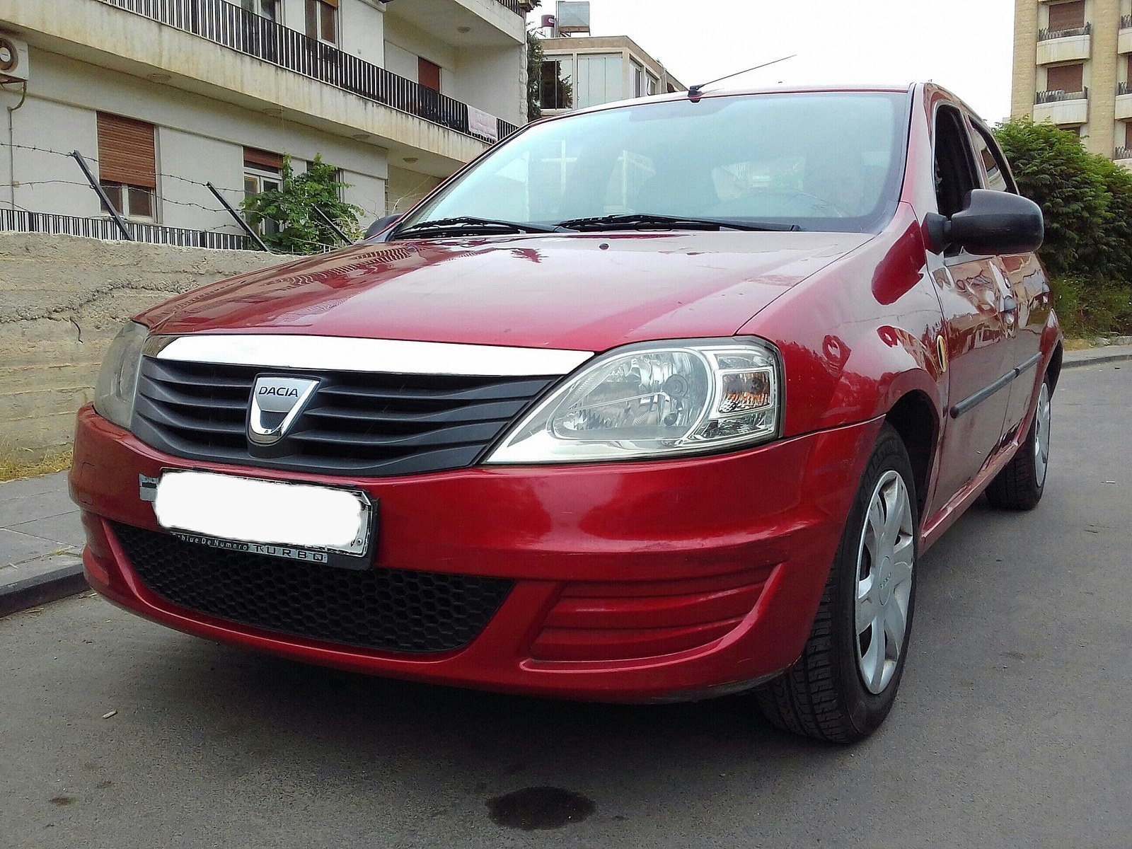 First-generation Dacia Logan 1.4 MPI in 2008 facelift form; correct model family and powertrain, but visibly later fascia/body details than the 2004 Romanian launch car.