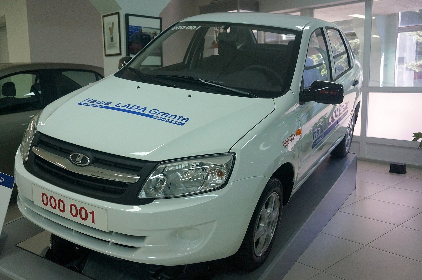 The source describes the first series-produced Lada Granta, standard trim, assembled 29 November 2011; exact launch-year production identity.