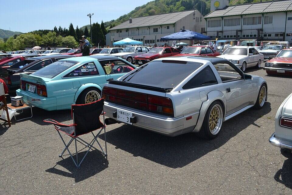 Commons shows an early Z31 300ZX Turbo beside a Japanese Fairlady Z 2BY2 300ZX T-bar. The two-car image supports generation and market family, not the profile's exact 1983 two-seat launch configuration.