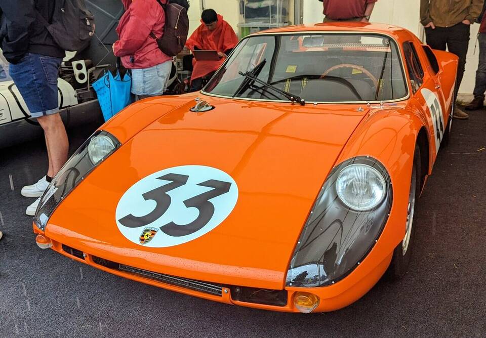 Commons identifies a 1964 Porsche 904 Carrera GTS. The survivor carries race numbers and should not be presented as proof of the profile’s road-delivery trim.