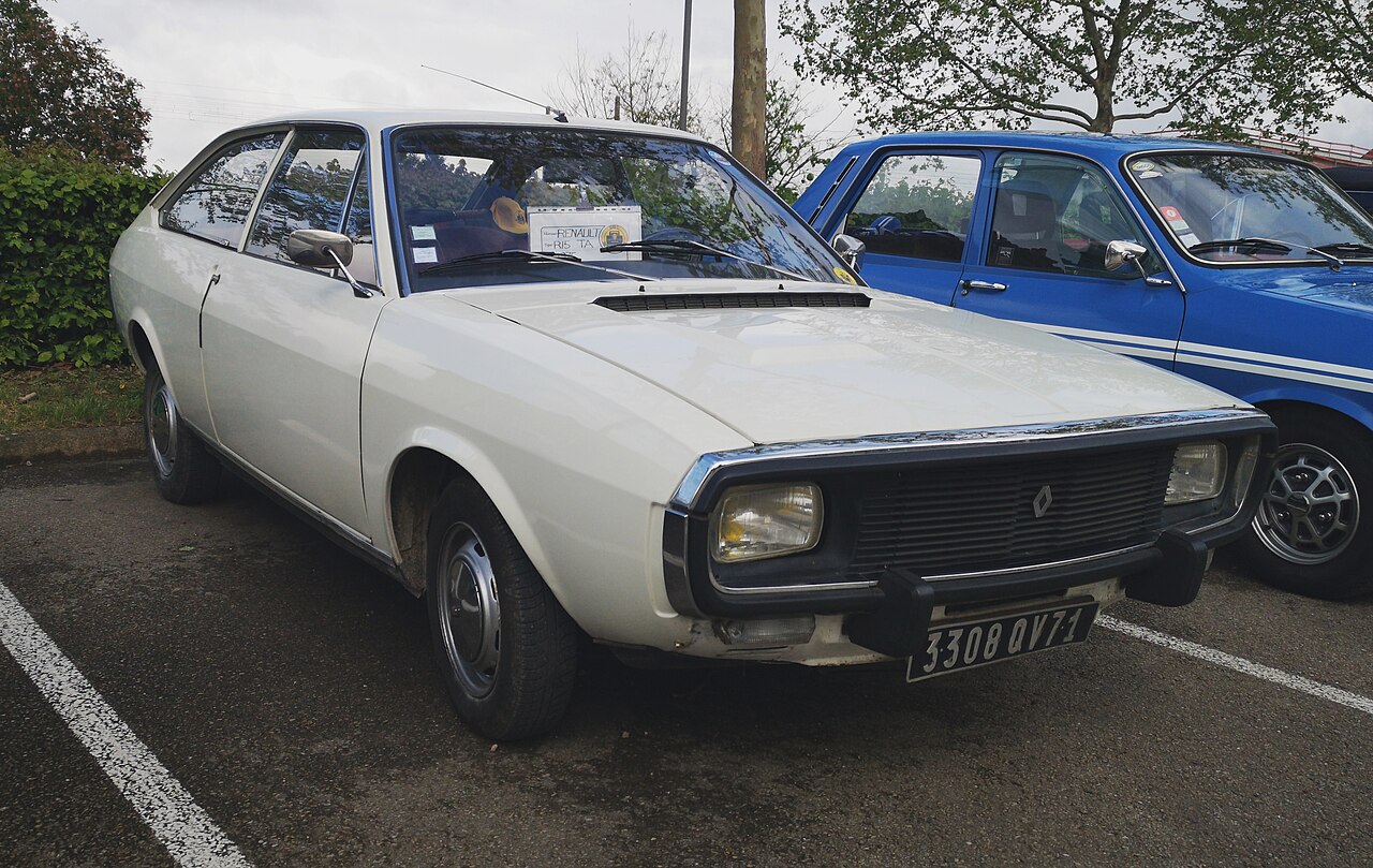 Representative white 1974 Renault 15 TL Automatique, photographed in 2019. Source identifies a 1.6-litre automatic: not the profiled 1972 1.3-litre four-speed manual. The blue car beside it is not the subject.