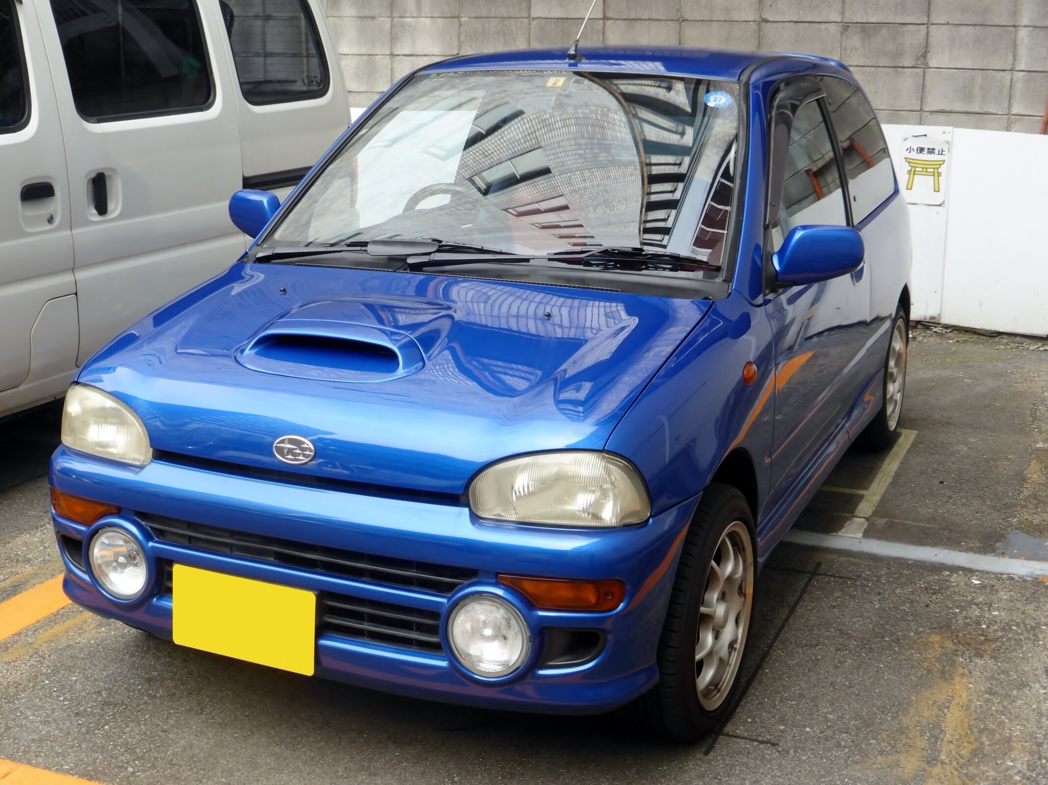 Exact RX-R KK4 trim/chassis family with hood scoop and auxiliary lamps; the file does not establish model year, so it is not claimed as a documented 1992 chassis.