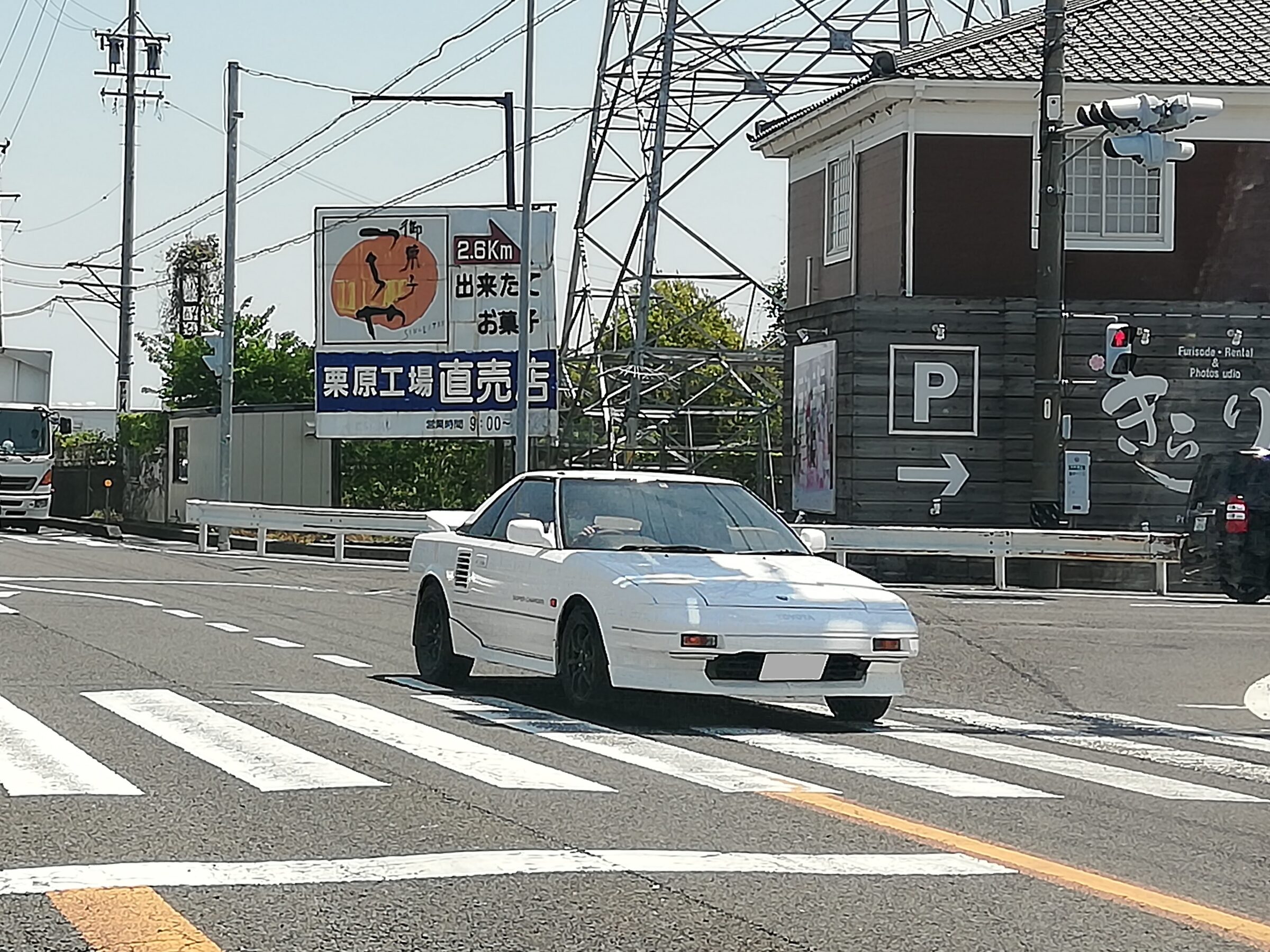Commons explicitly identifies Japan-market AW11 G-Limited Super Charger model codes; side decal is visible.